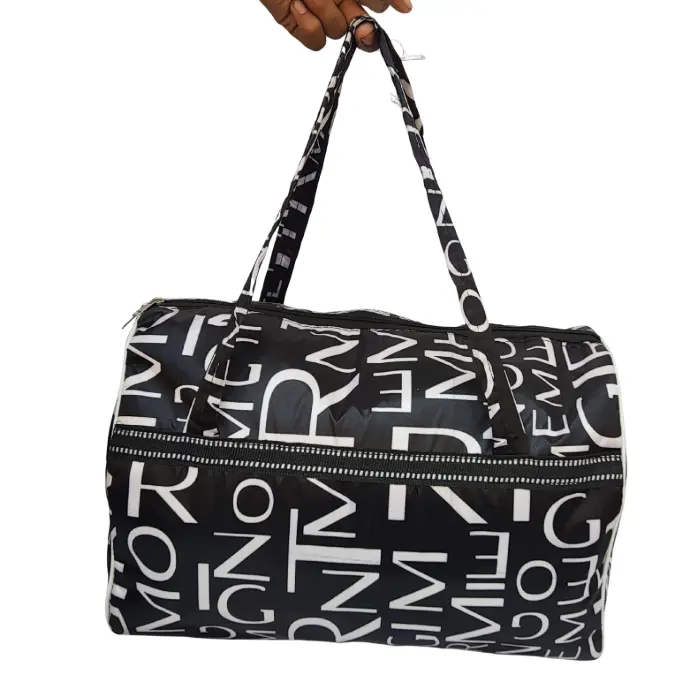 Black and white letter print duffel bag with long top handles, white piping, and a front zippered pocket, suitable for use as a gym bag or light travel luggage.